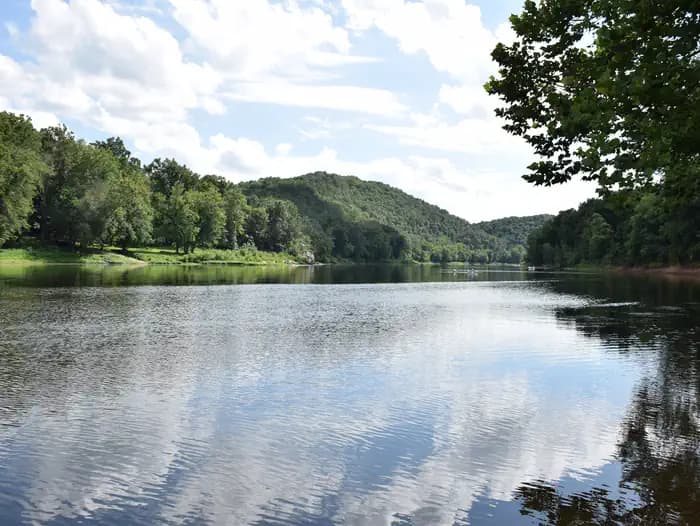 The Potomac River reflects a blue sky and fluffy clouds at McCoys Ferry