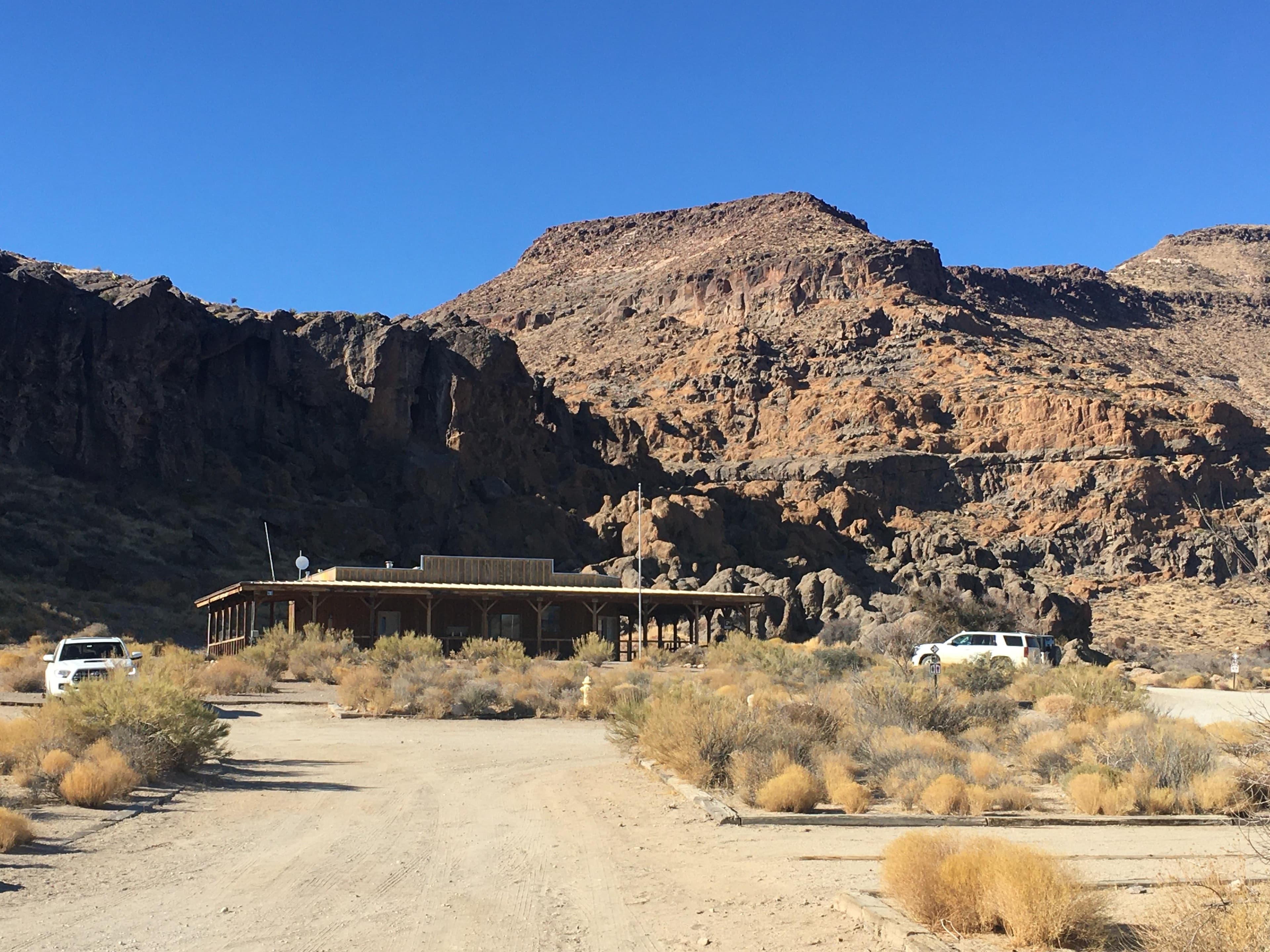 Building with rock formations behind