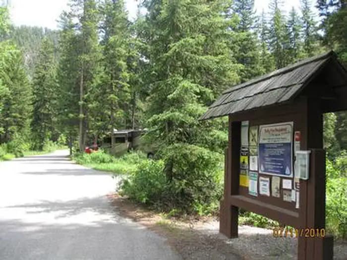 Swan Creek Entrance - Information board, road, RV and pine trees