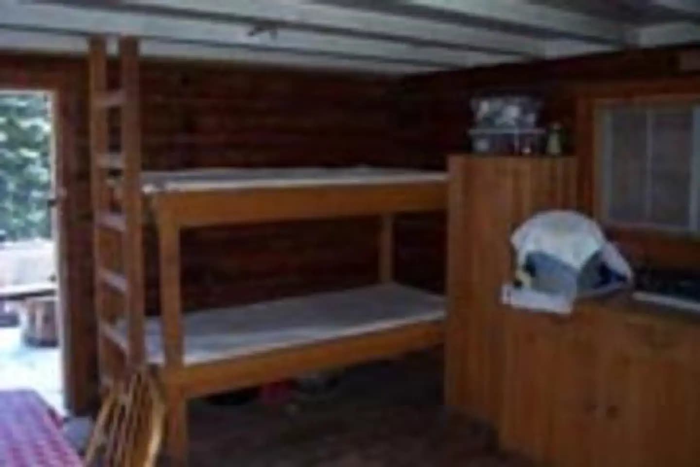 Inside view of the cabin with bunkbed and cabinet storage