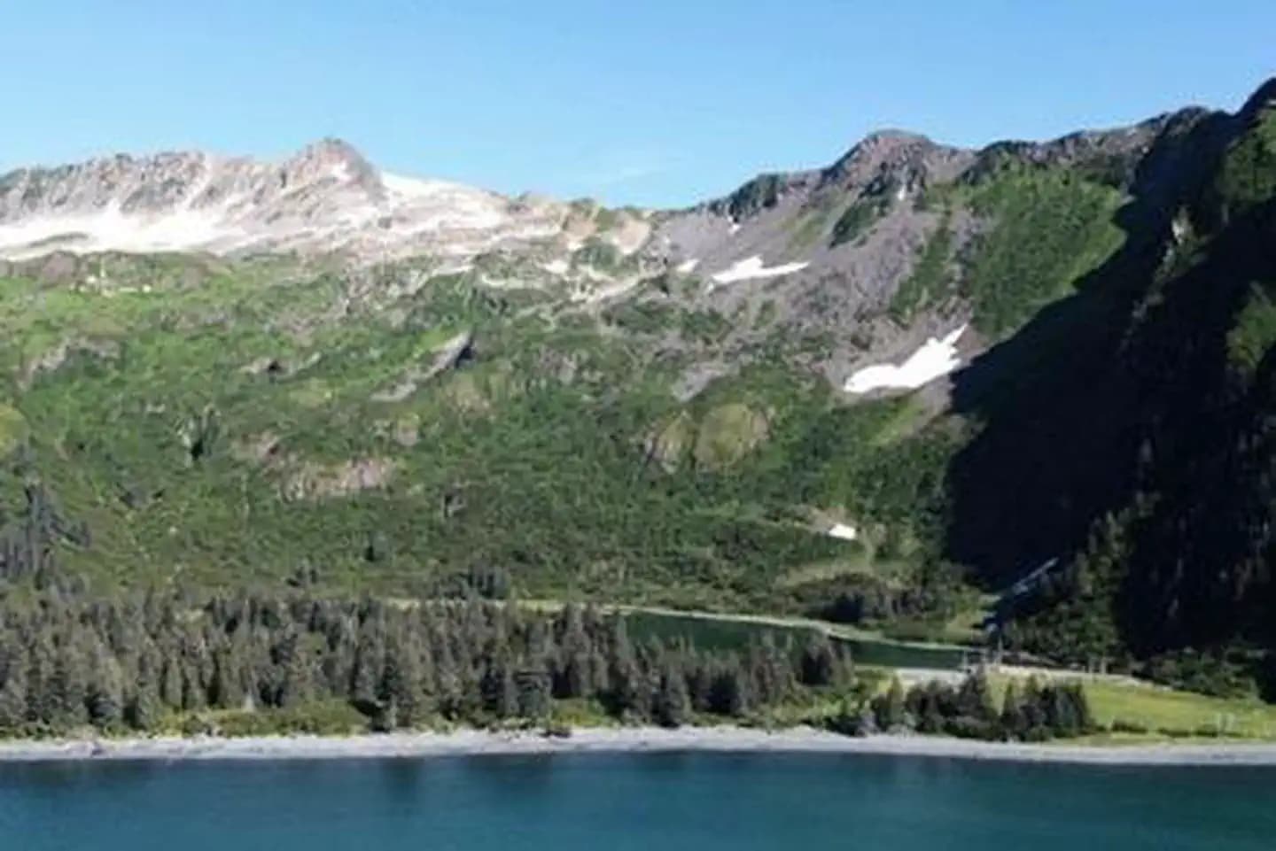 Glacier-carved peaks at Kenai Fjords National Park with the bay in the foreground