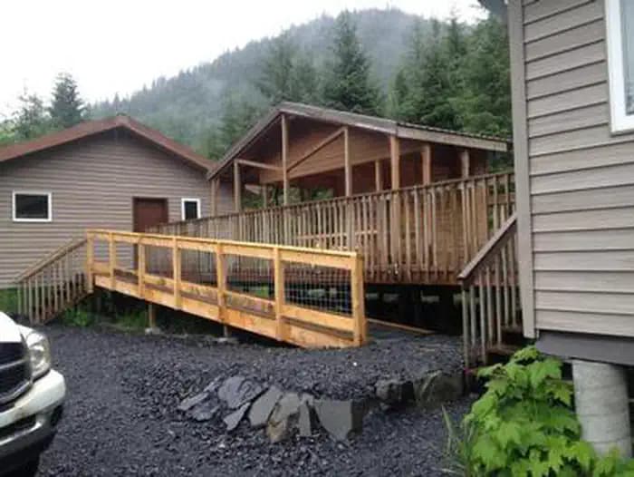 Deep Bay Cabin exterior with accessible ramp to the porch and gravel driveway in foreground