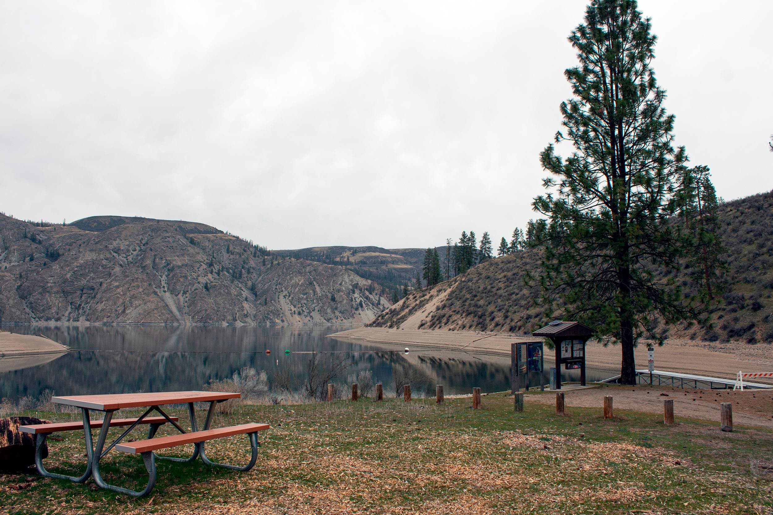 A view through a waterfront campsite to the boat launch.