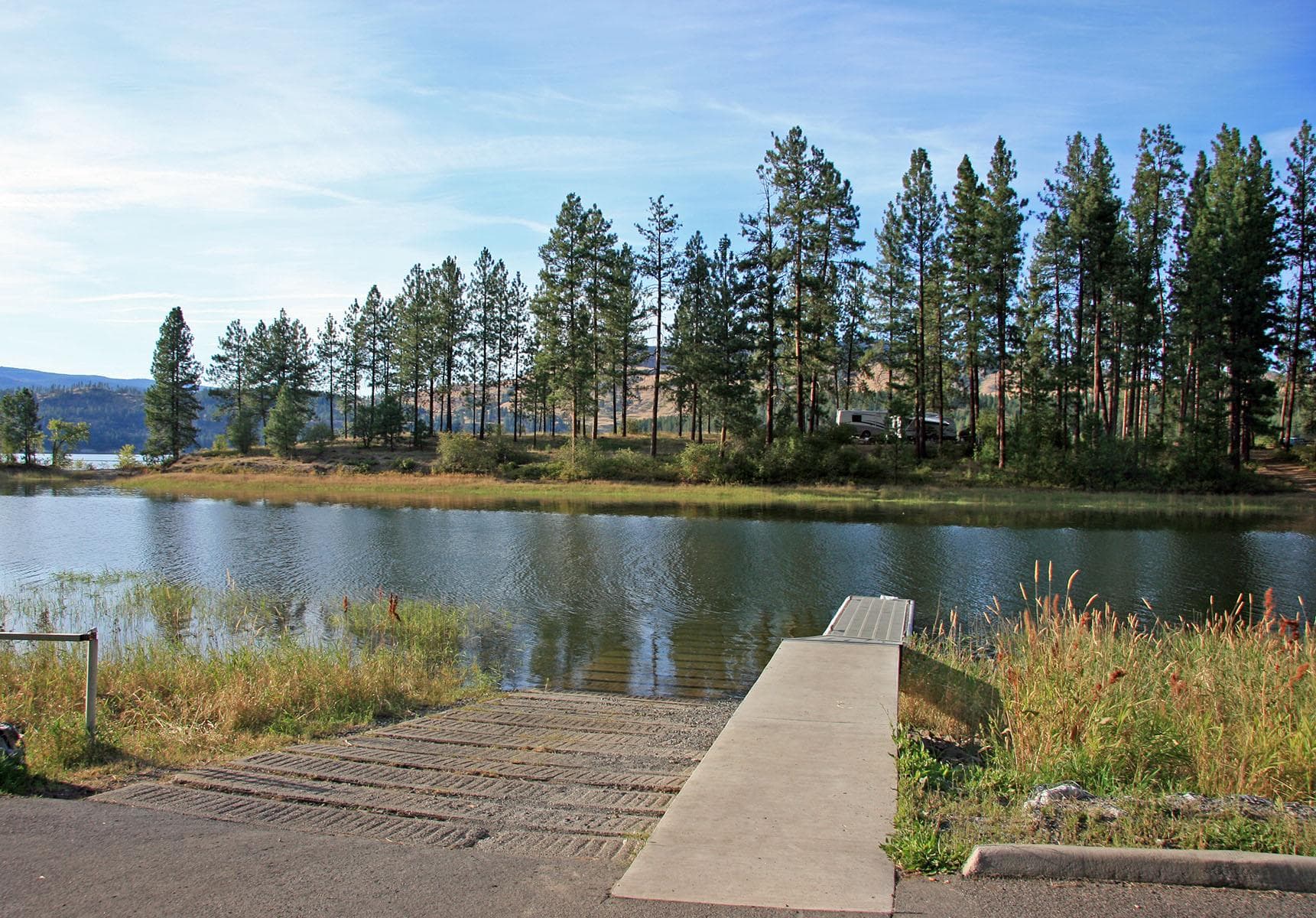 The boat launch and parking area is located at the head of the single-lane campground access road.