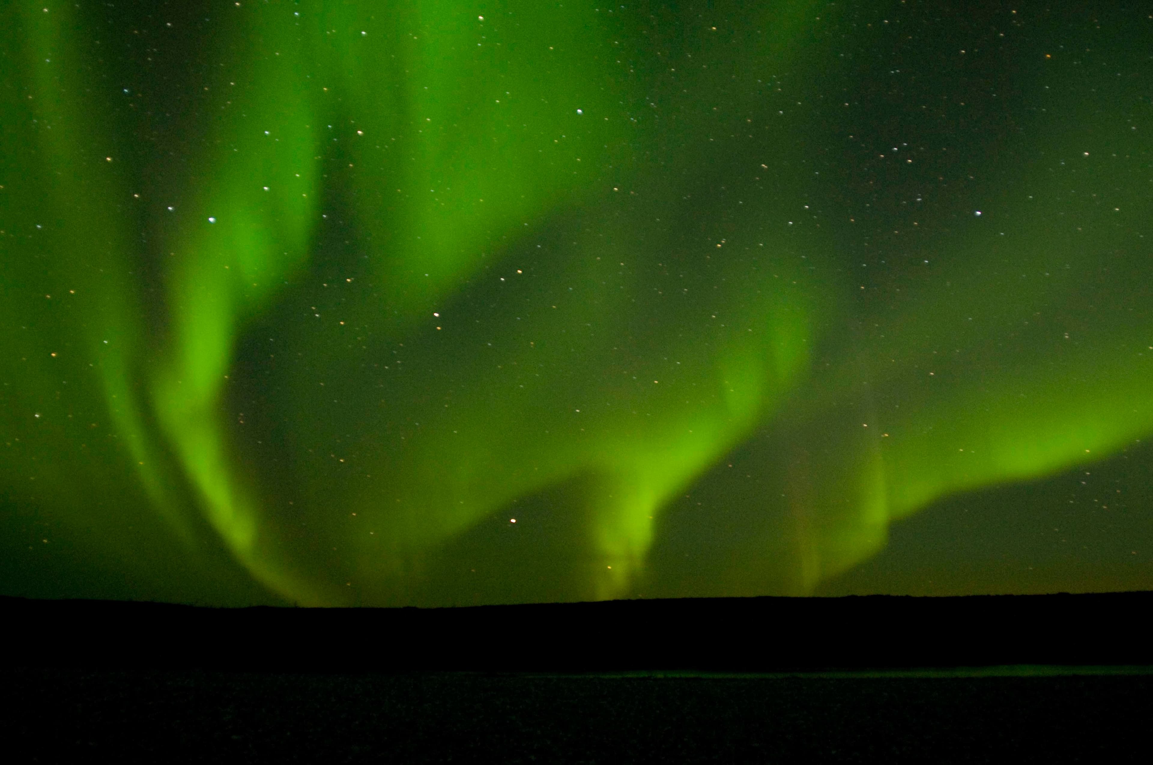 A huge spray of northern lights is reflected in a tiny sliver of water in the Noatak River. This image was captured in early September at 2:30 in the morning.