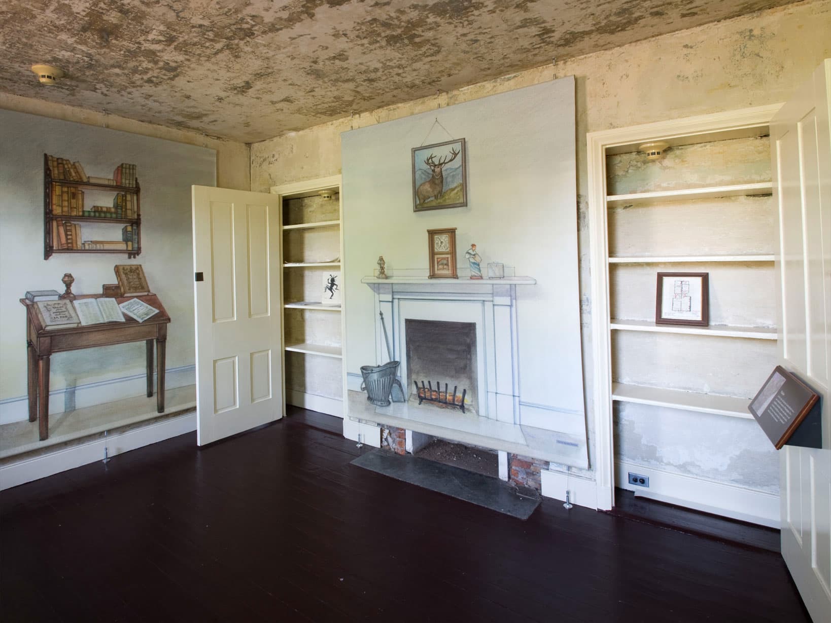 Wall mounted illustrations show how the room may have been furnished when Edgar Allan Poe lived in the house.