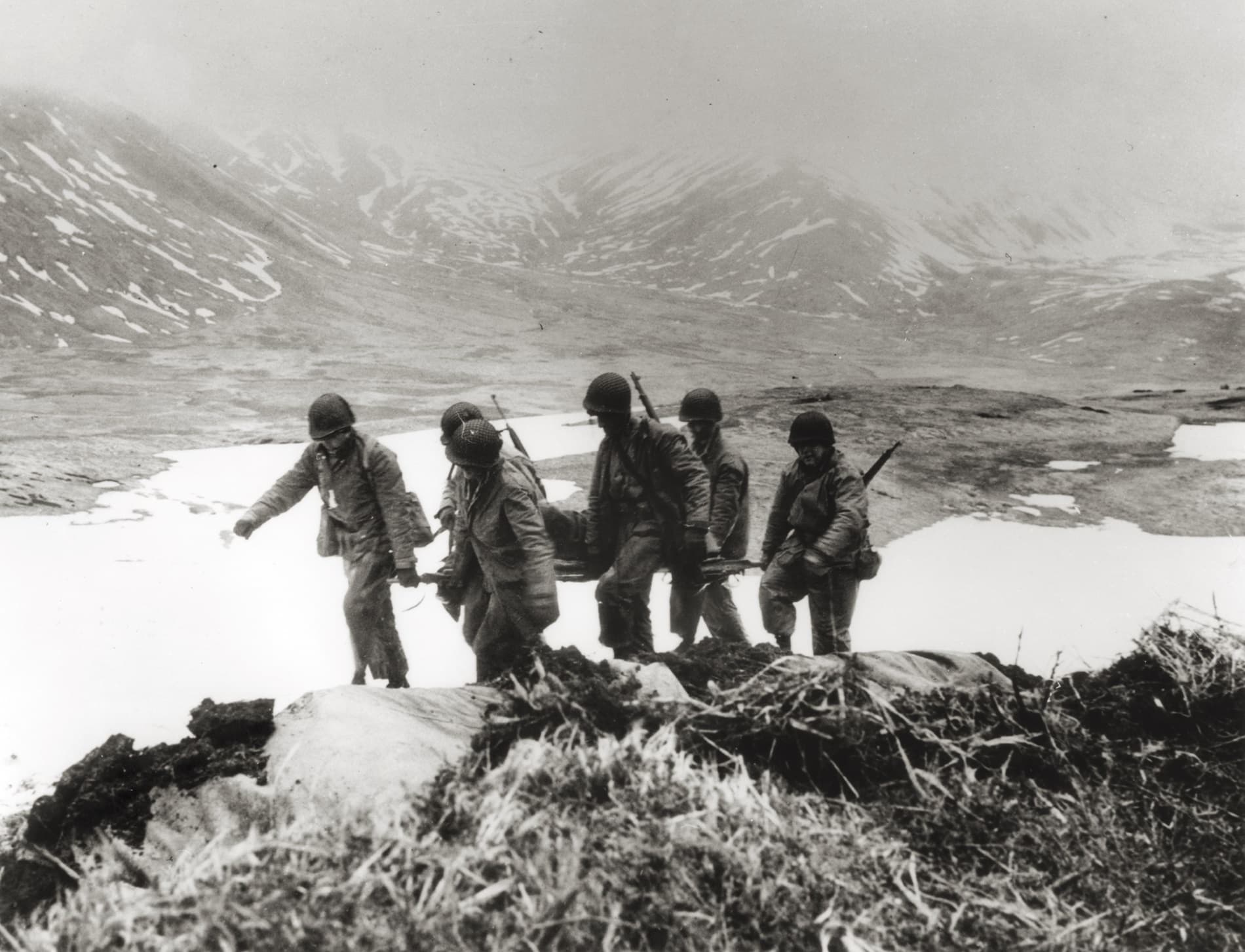 U.S. wounded are gathered from the battlefield on Attu Island.  The battle on Attu, lasting nearly 20 days, was the second most deadly in the Pacific Theater.