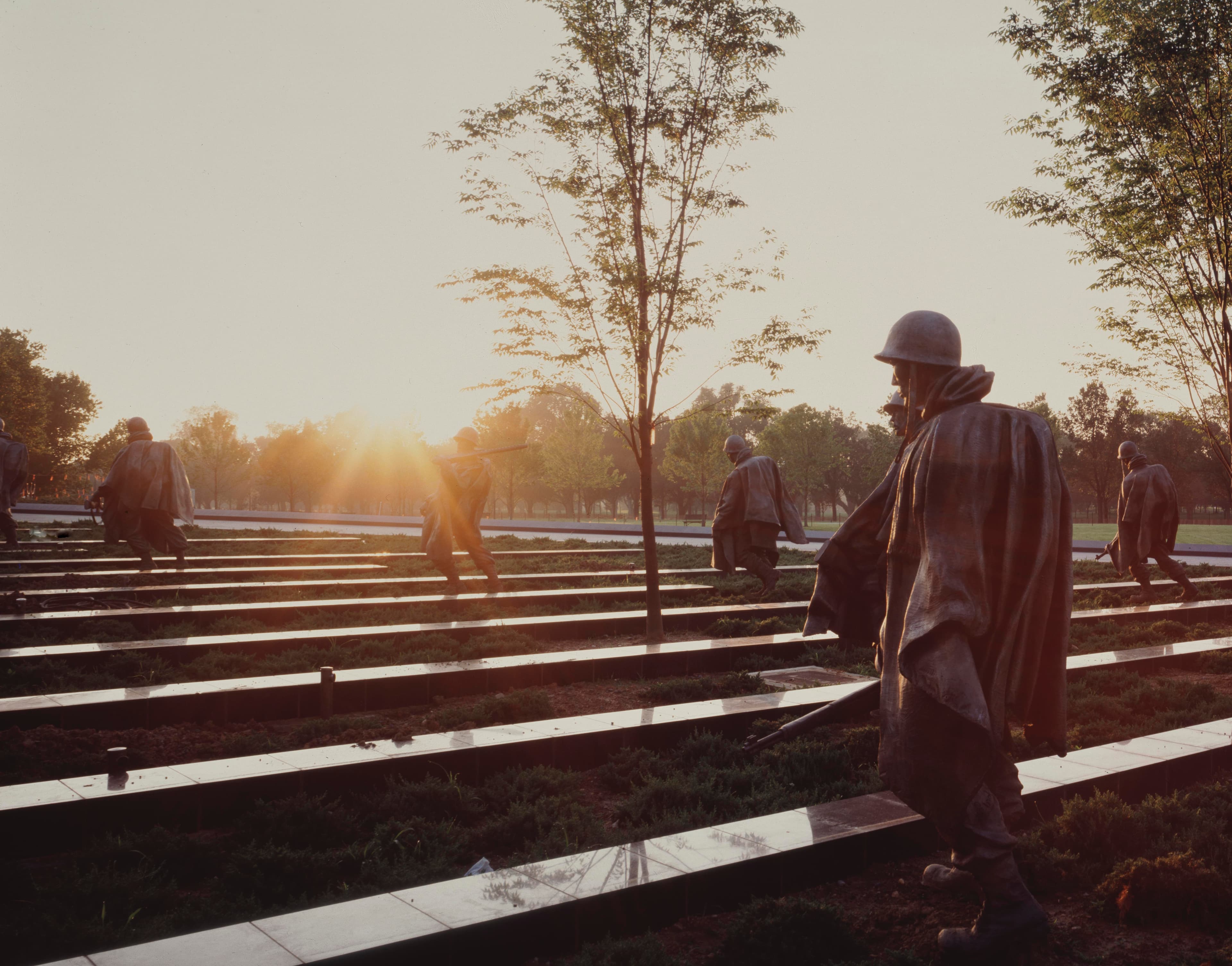 Sun Rises over the statues of the Memorial