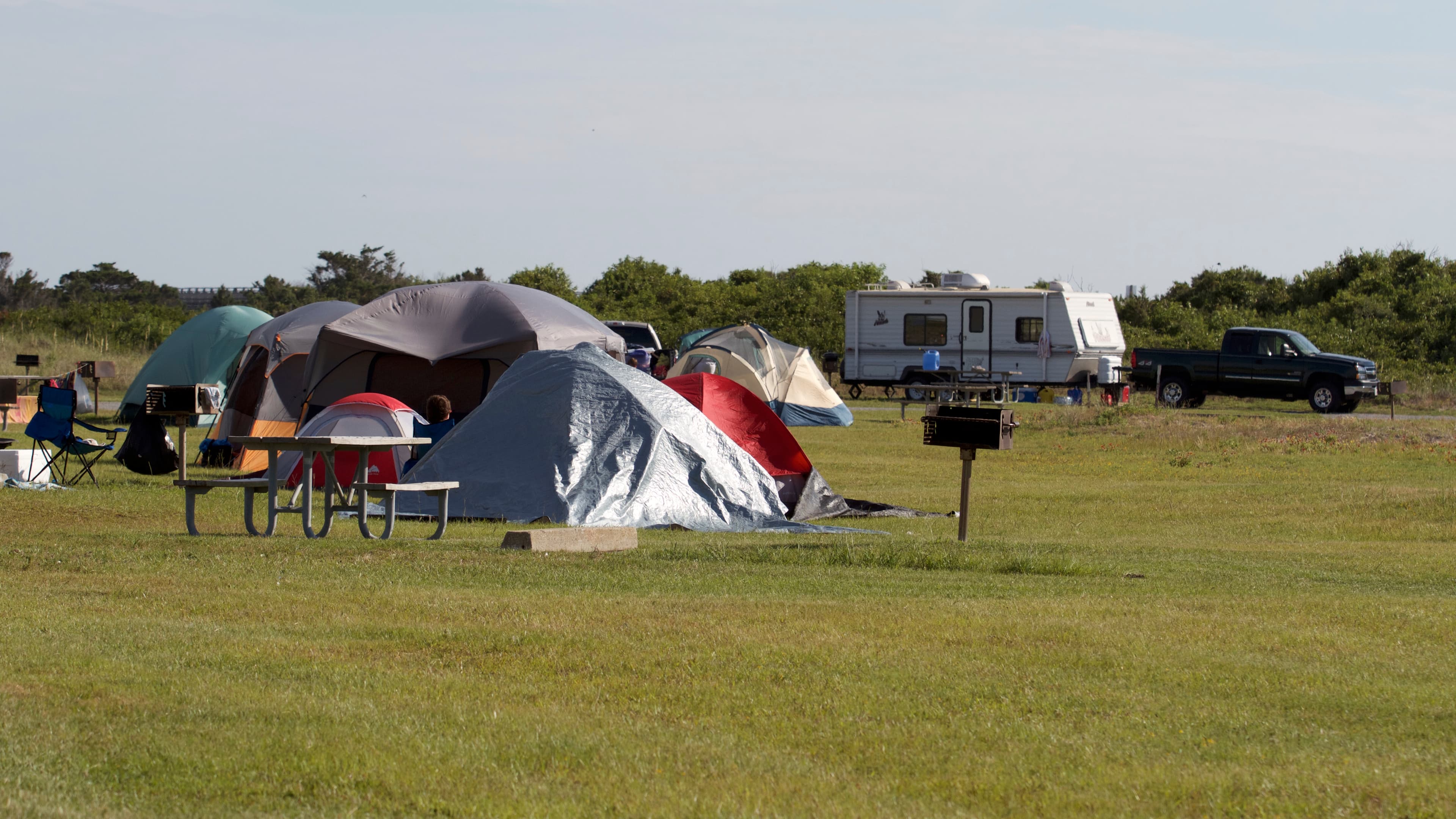 Tents and a camper at the Oregon Inlet Campground.