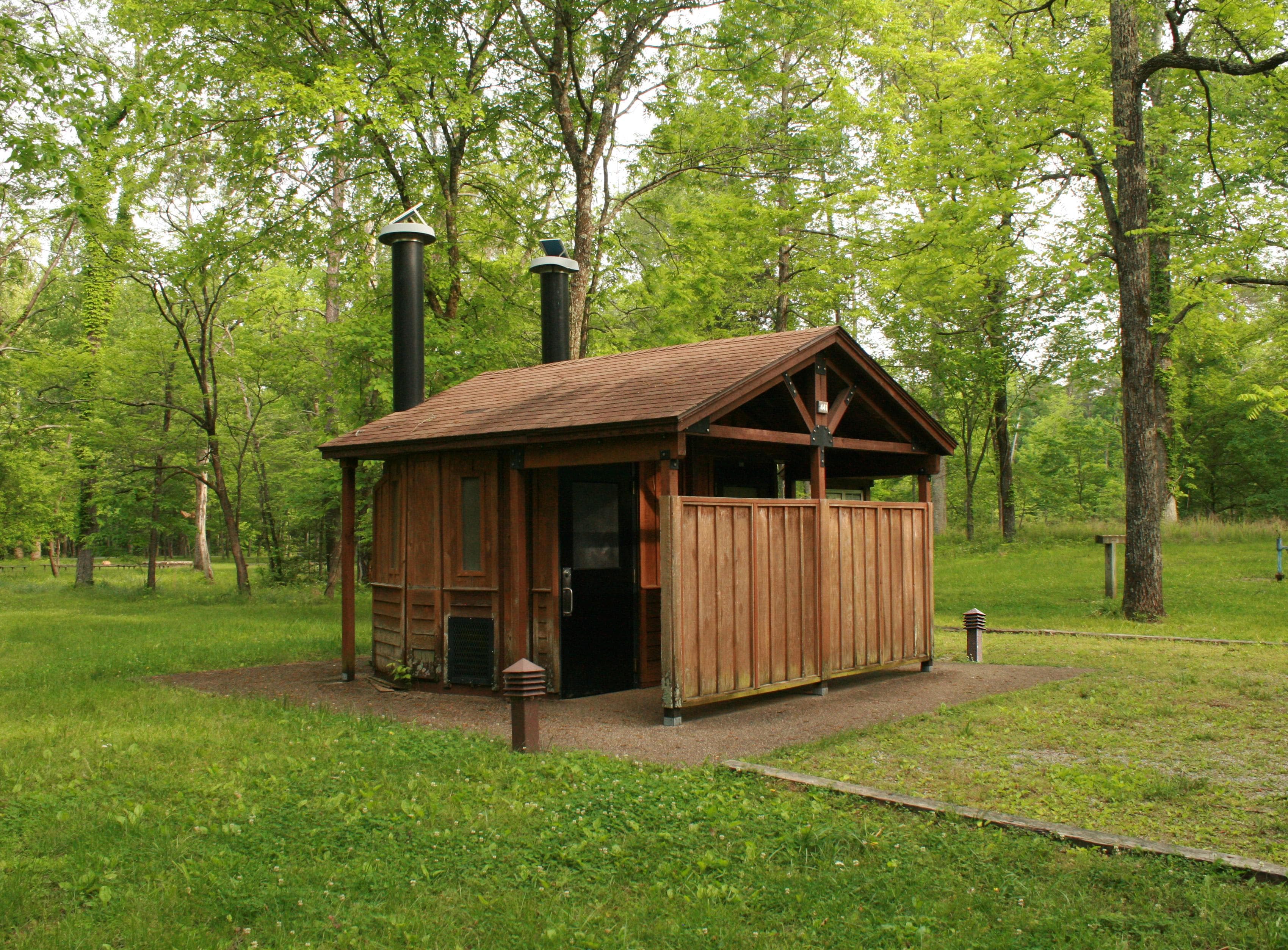The restroom facilities at Maple Spring Group Camp feature pit toilets.