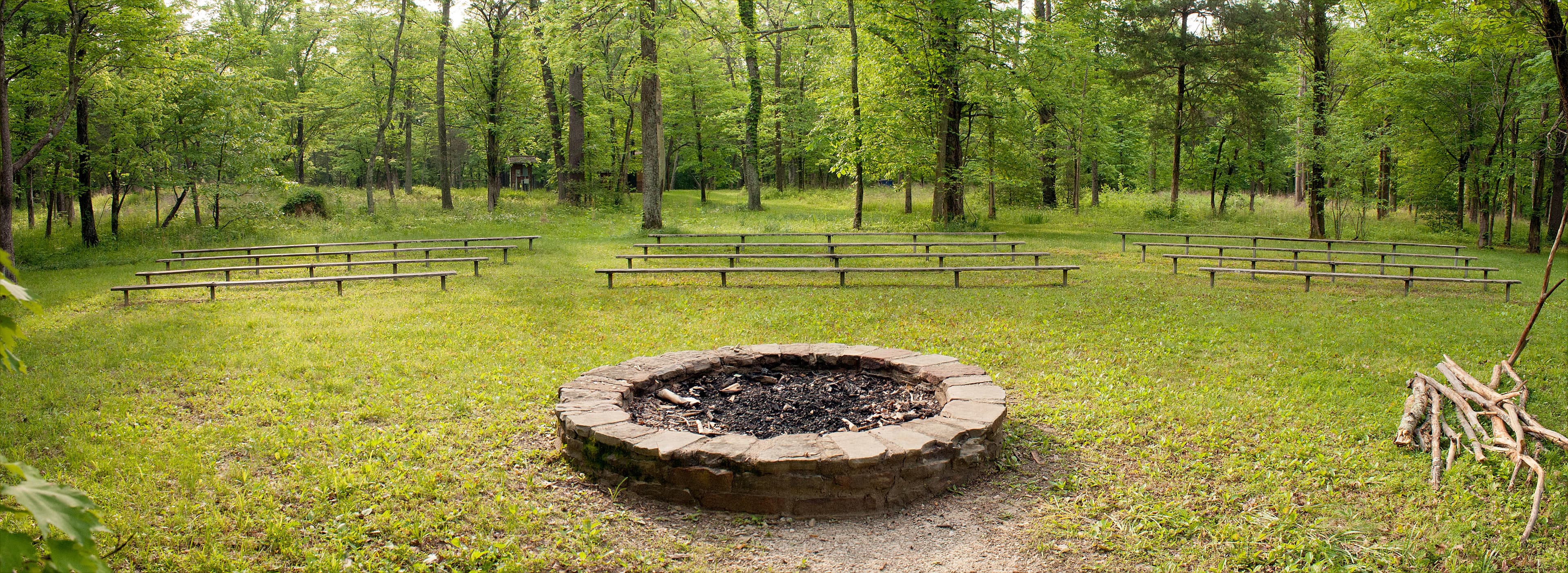 A campfire circle offers a place for woodland stories at Maple Springs.