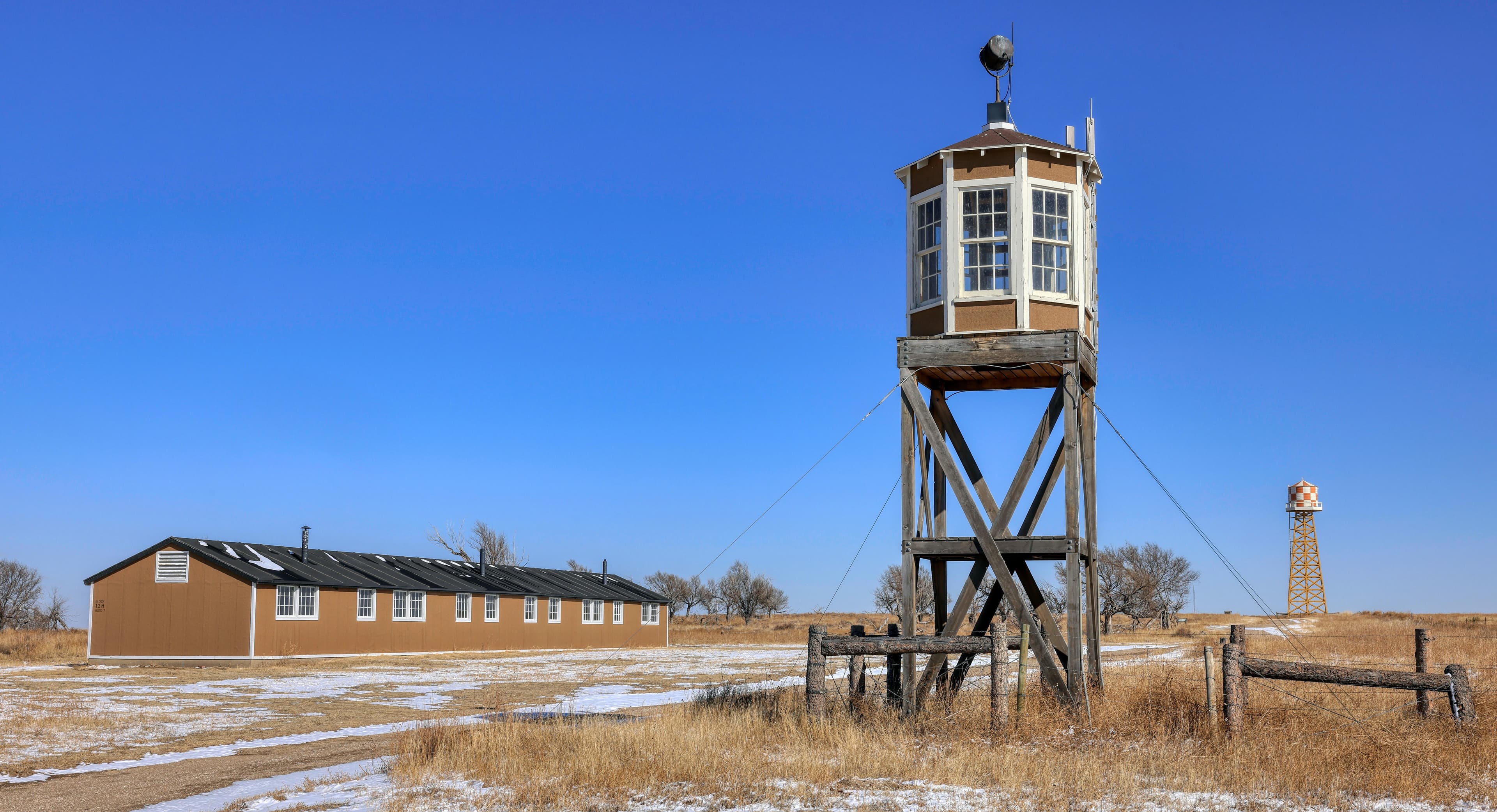 Reconstructed barracks, guard and water towers at the newly designated Amache National Historic Site