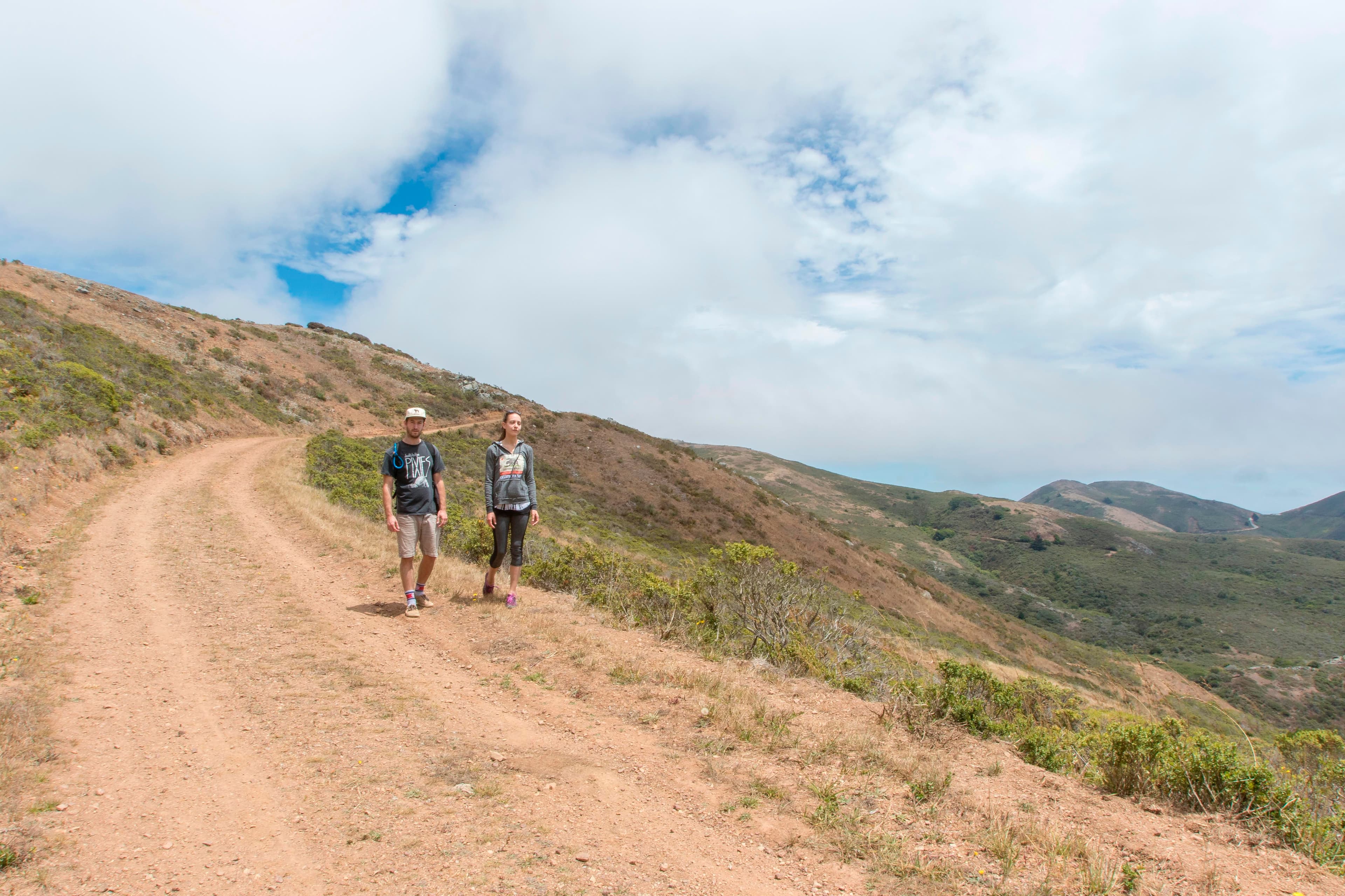 Two hikers walk the fire road.