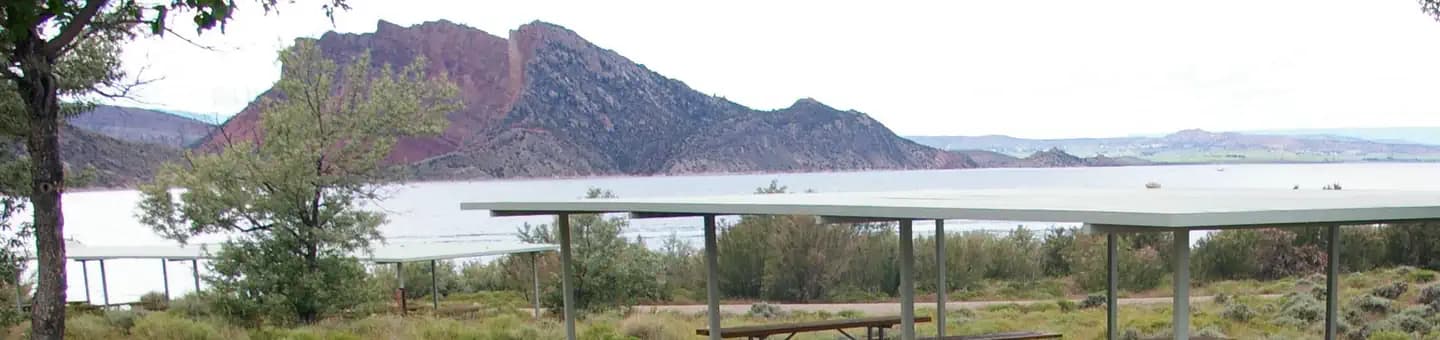 Pavillion with lake and mountain in the background.